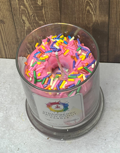 Jar glass candle. Wax donut with sprinkles in the middle of the glass.