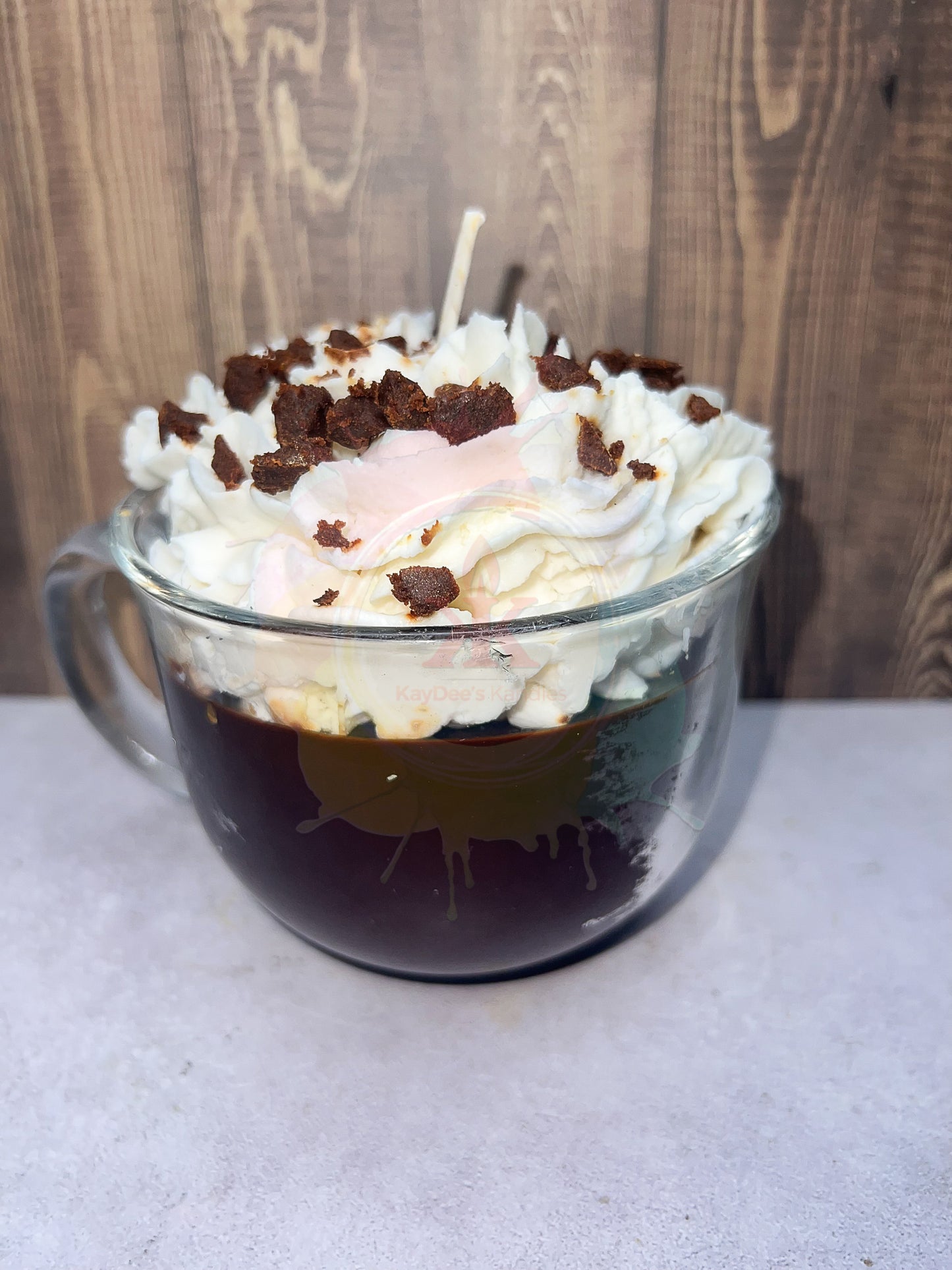 Photo of hot chocolate candle with wax whipping on top. Front view