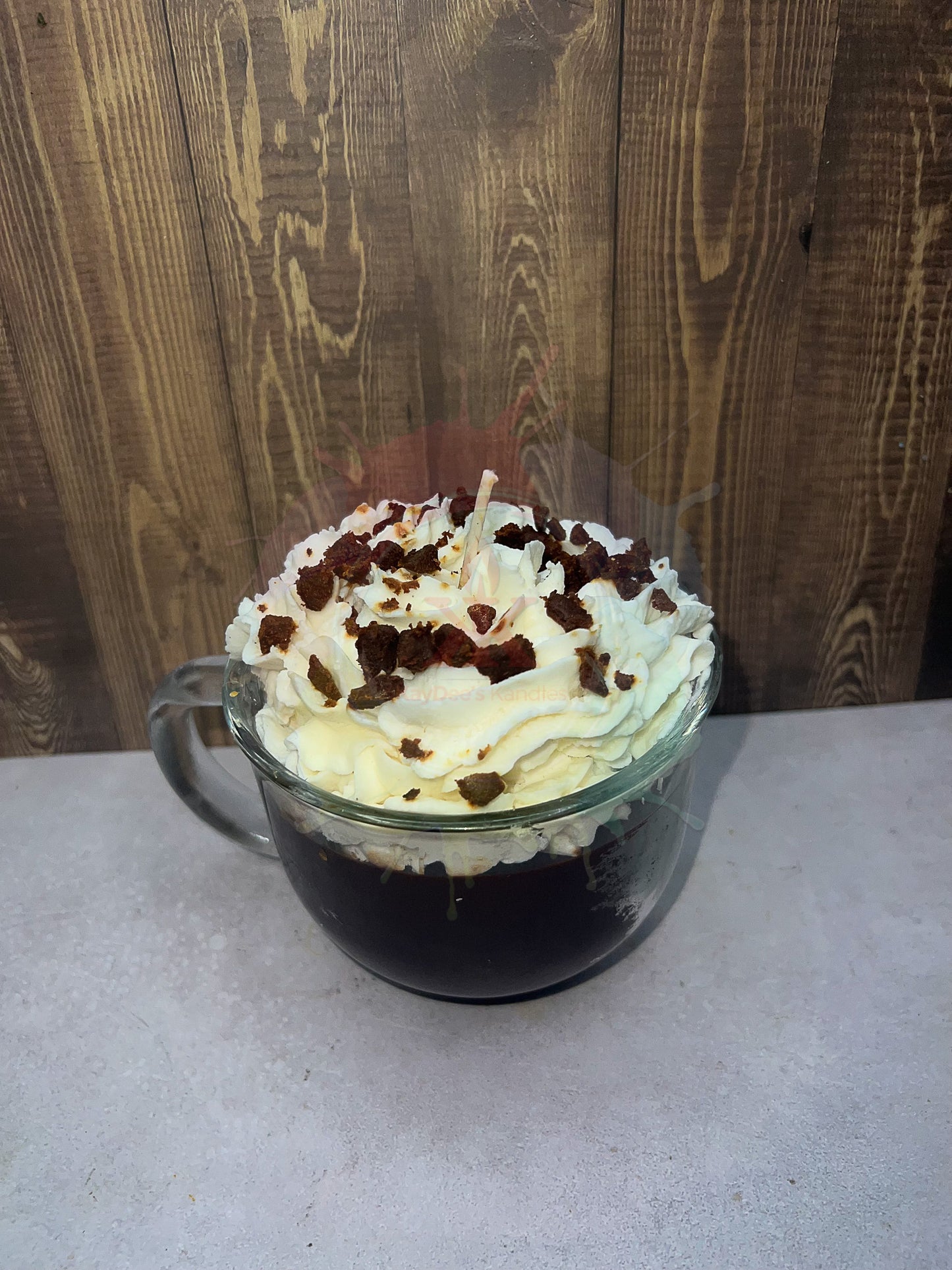 Photo of hot chocolate candle with wax whipping on top. Top view