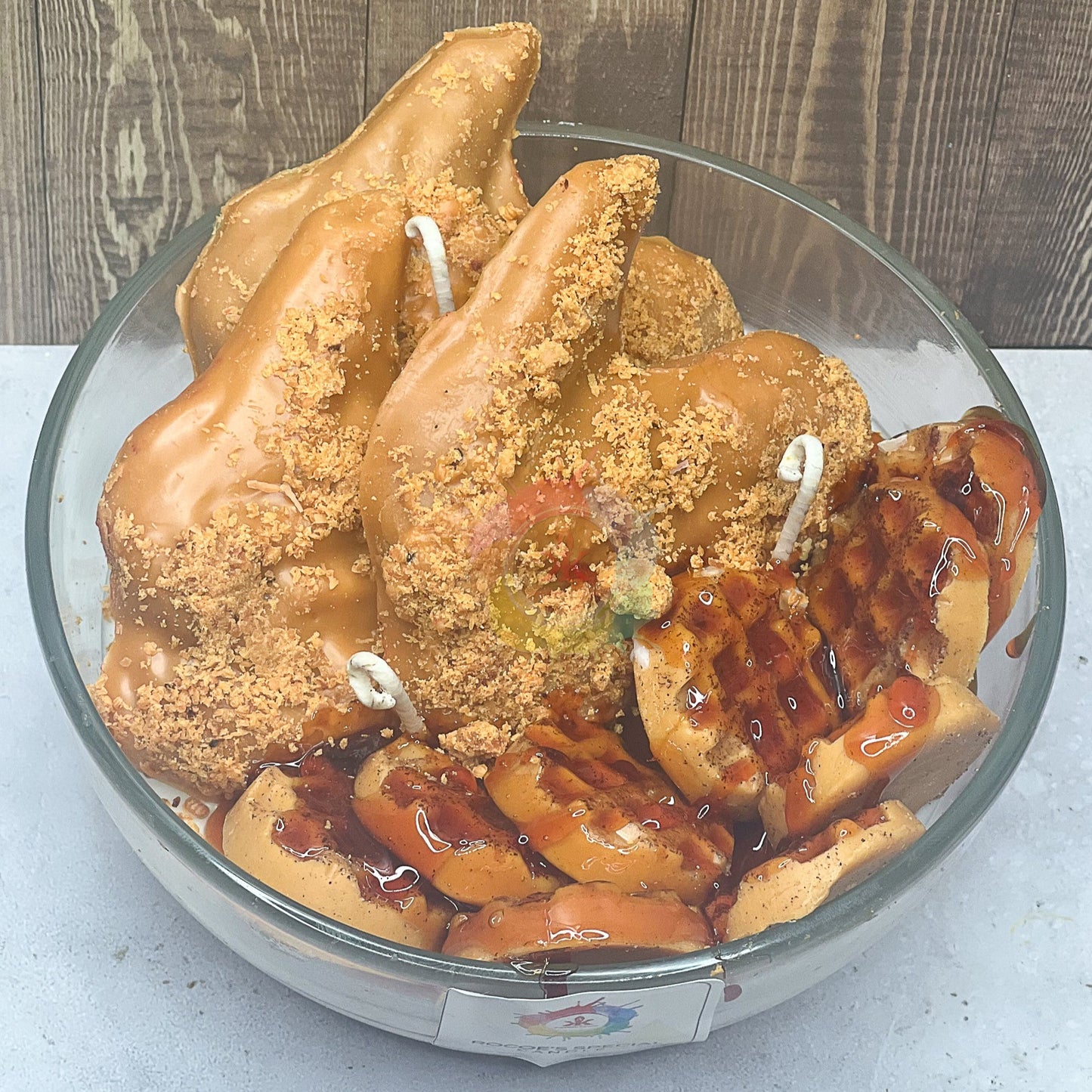 Photo of glass candle. candle mimic fired chicken and waffles with maple syru