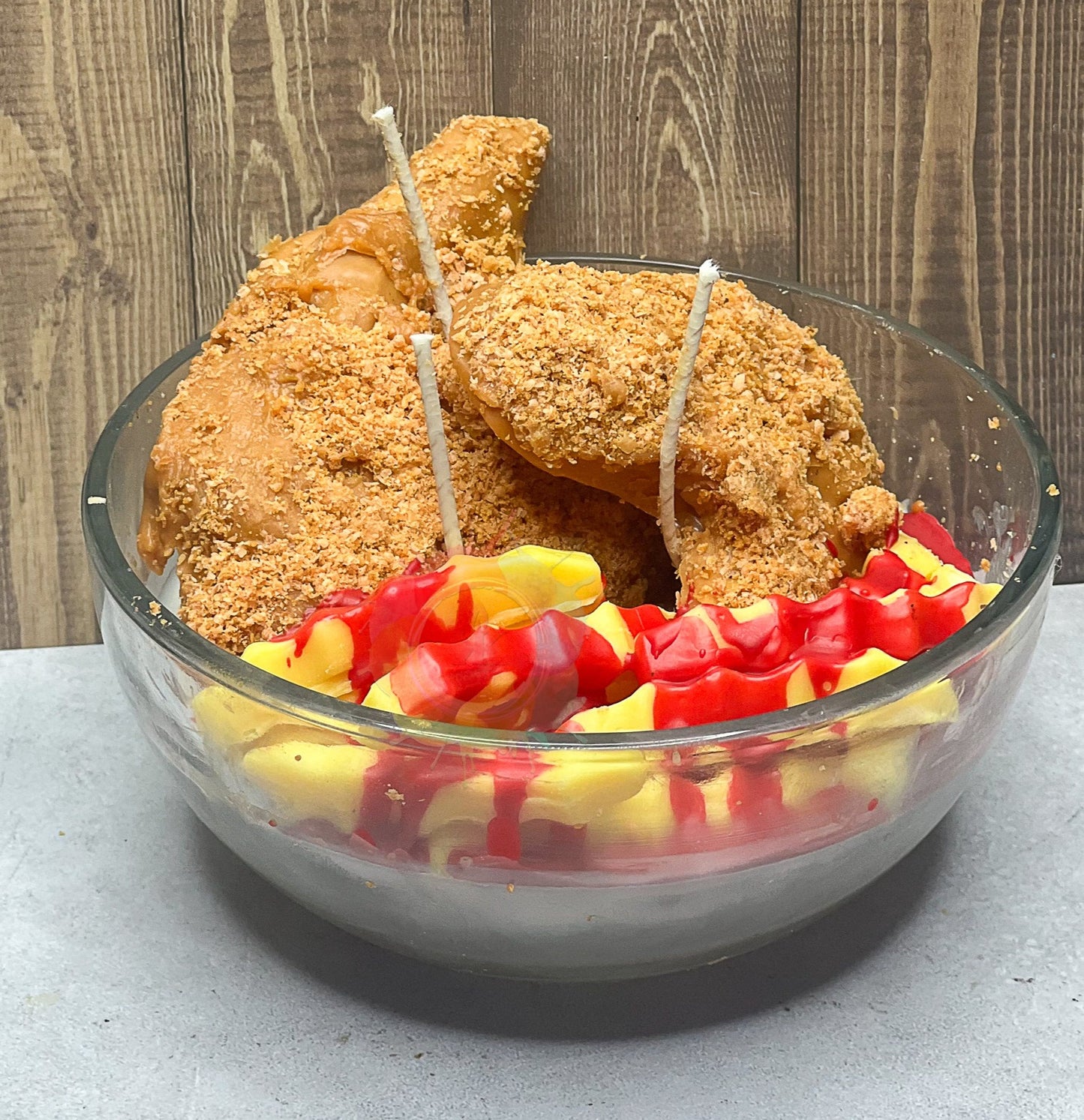 Photo of candle in glass bowl; candle designed to look like Fried chicken and French Fries with ketchup.