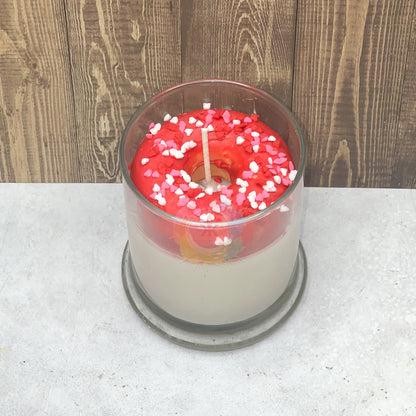 Photo of donut candle. Wax Donut sitting in glass.