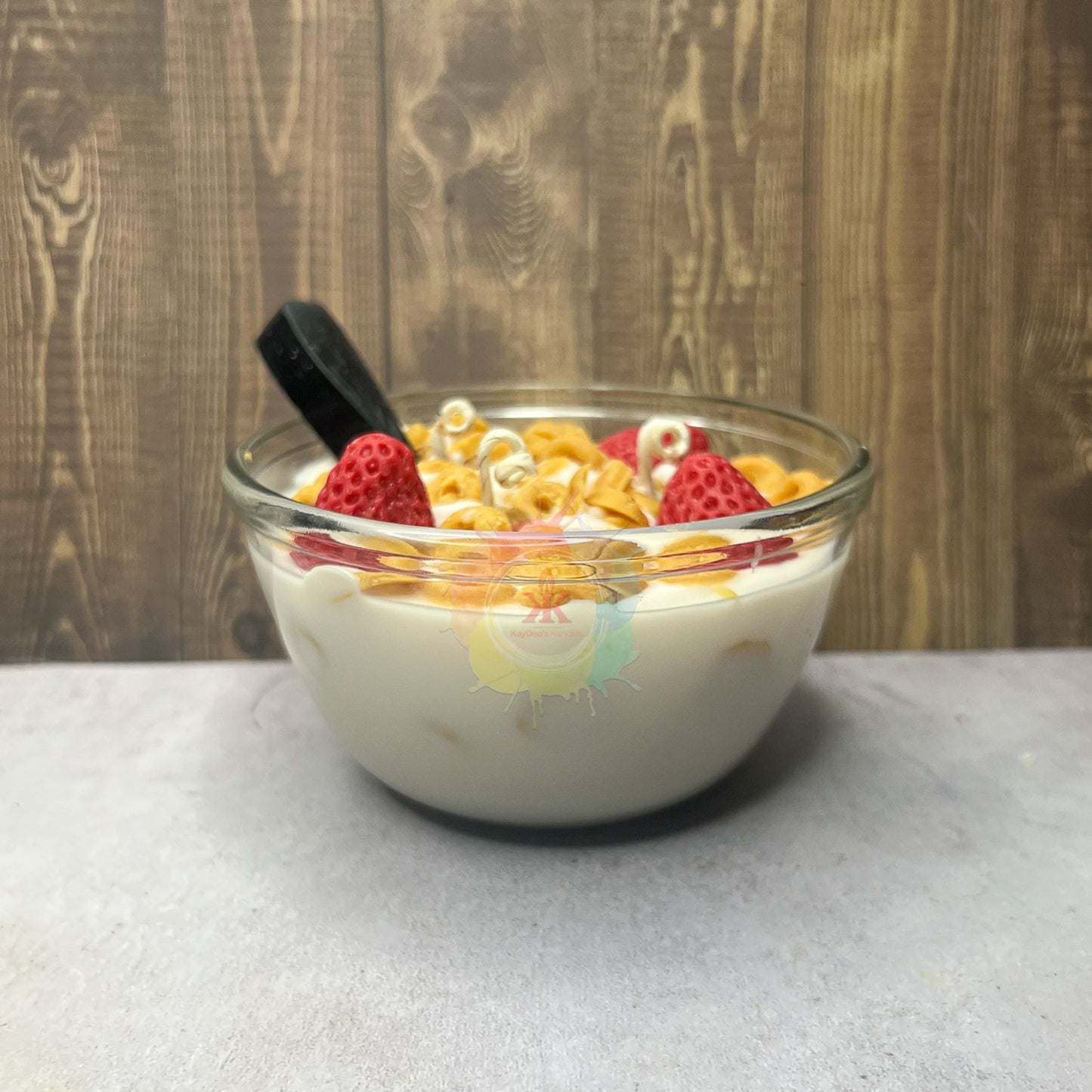 Photo of bowl of cereal. Cheerios and Strawberry candle made to mimic real bowl of cereal.
